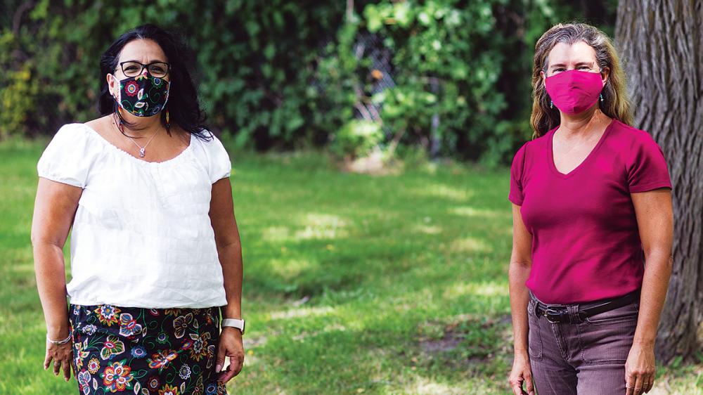 Jennifer Baron and Towana Brooks standing outside wearing masks while social distancing