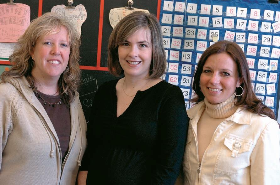 Three woman teachers posing in classroom