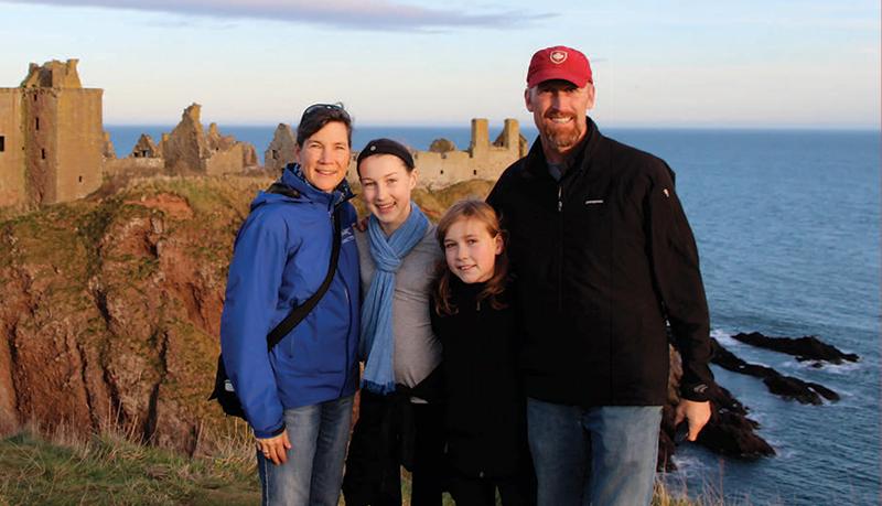 Michelle Richardson Family standing on cliff in Scotland