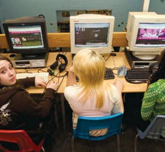 students sitting in computer lab working on computers