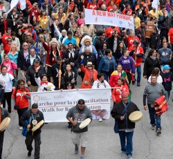 Aboriginal community members marching down street