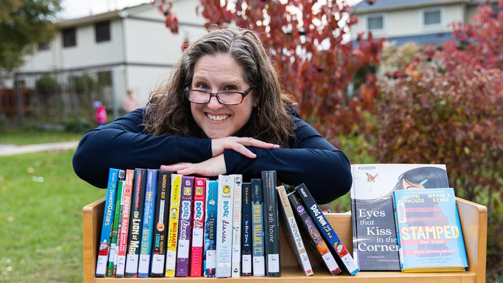 Diana Maliszewski posing outside with books