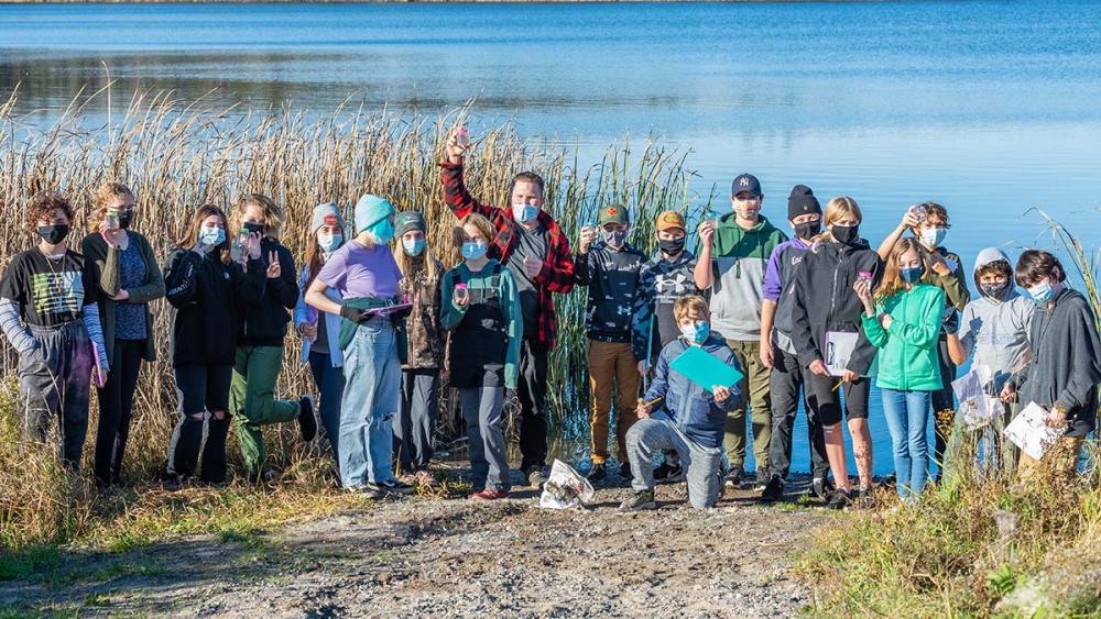 Classroom standing in front of lake