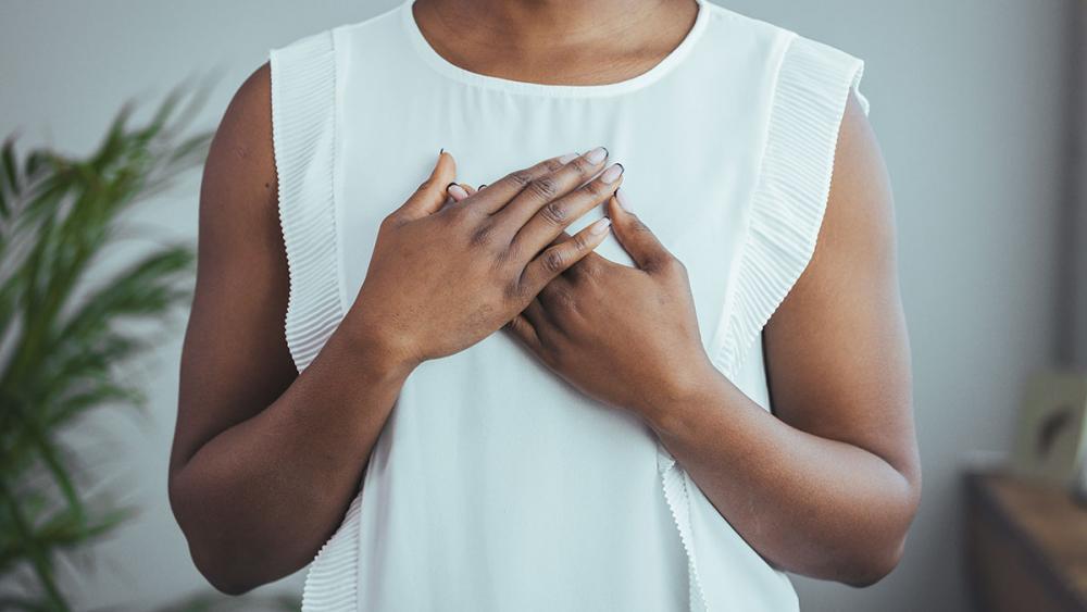 Woman holding hands to chest