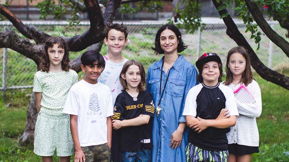 Gradeschoolers standing outside with their teacher