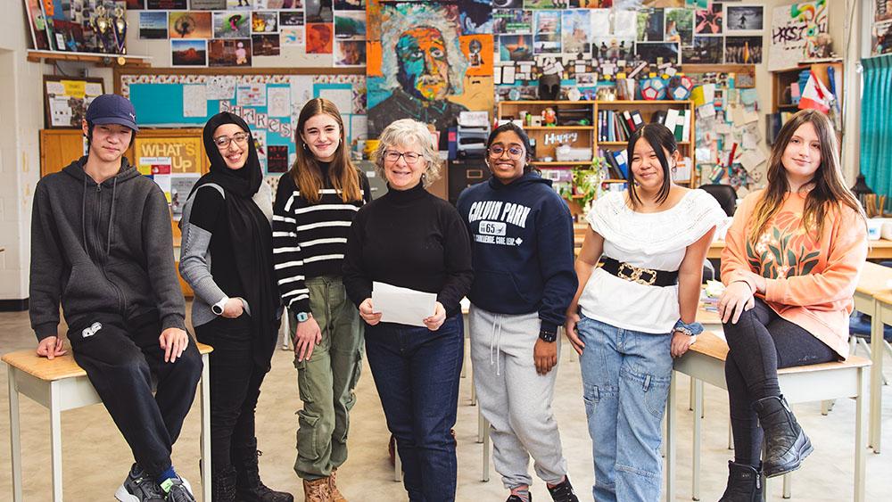 Dawn Williams posing with students in classroom