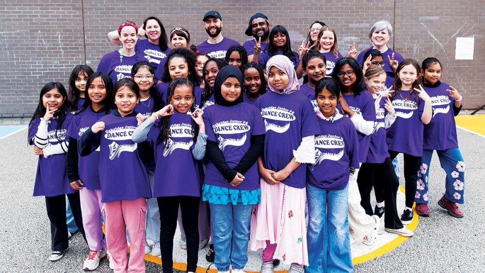 Dance Crew students and teachers posing outside of school