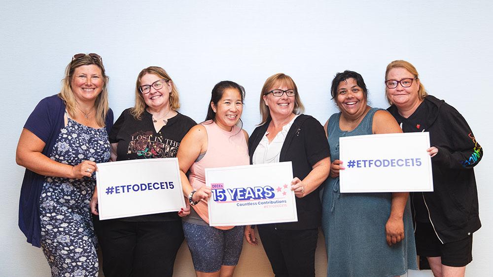 ETFO members holding up signs that celebrate 15 Years of DECE Members' Countless Contributions
