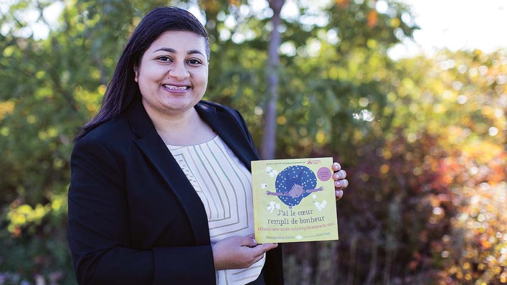 Asha Nagpal posing with book