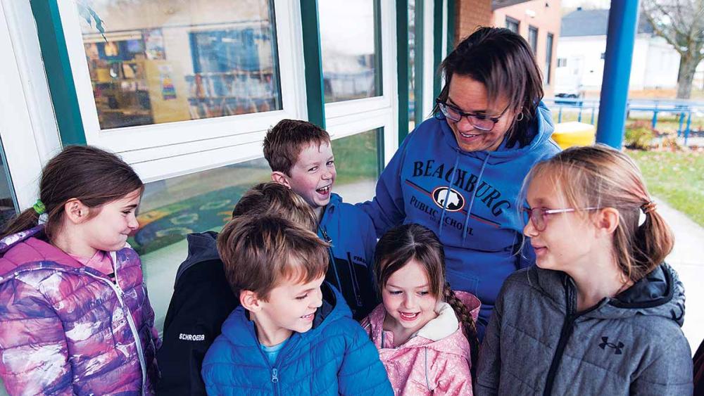 Nancy Campbell and her class standing outside of school