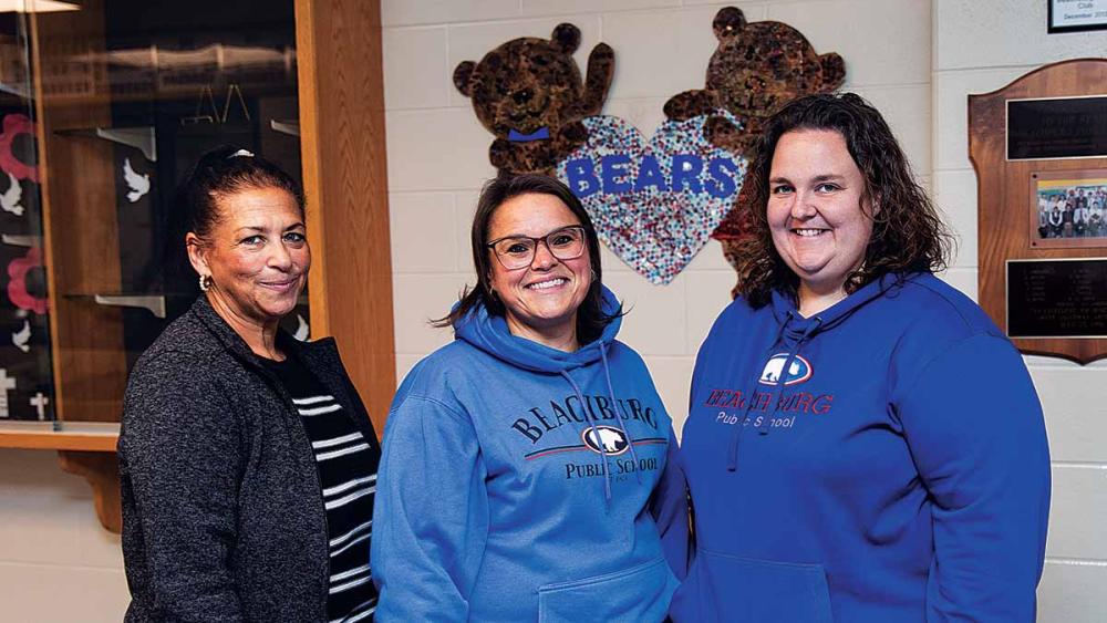 Nancy Campbell and other ESP's standing in school