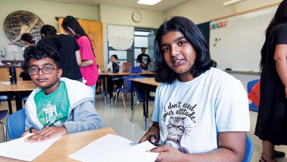 Students working on care cupboard sign