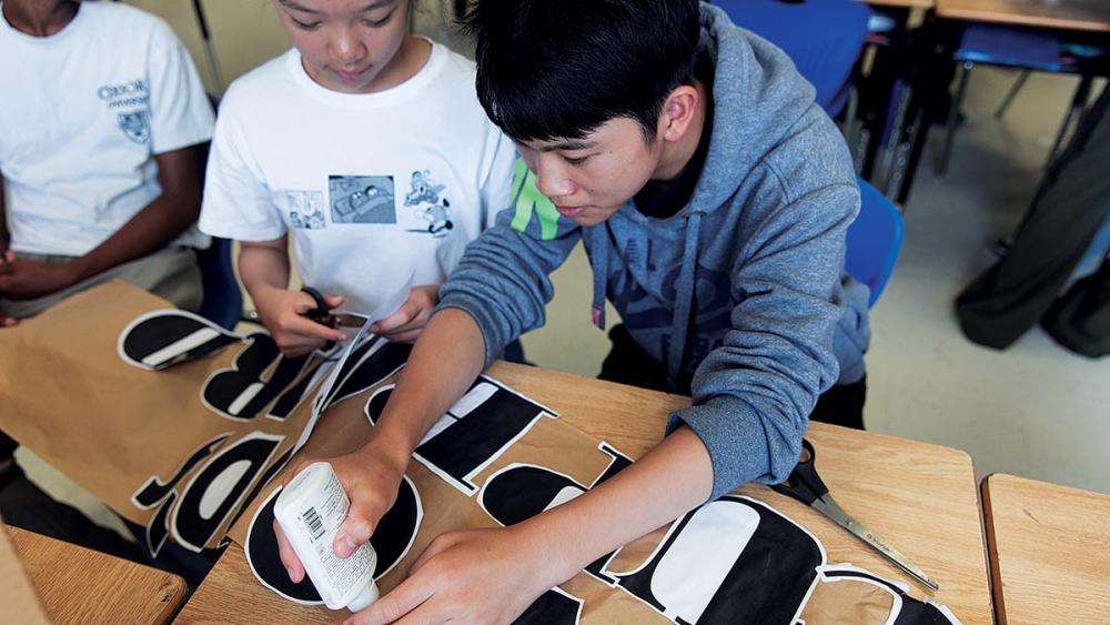 Students working on care cupboard sign