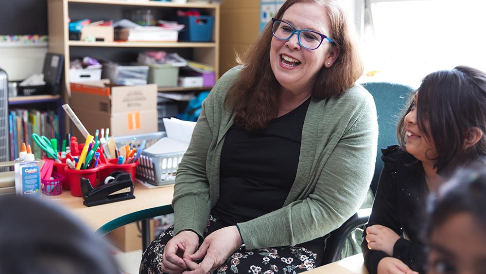 Heather Thompson smiling while teaching students in classroom