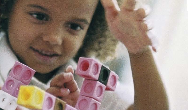 young girl playing with legos