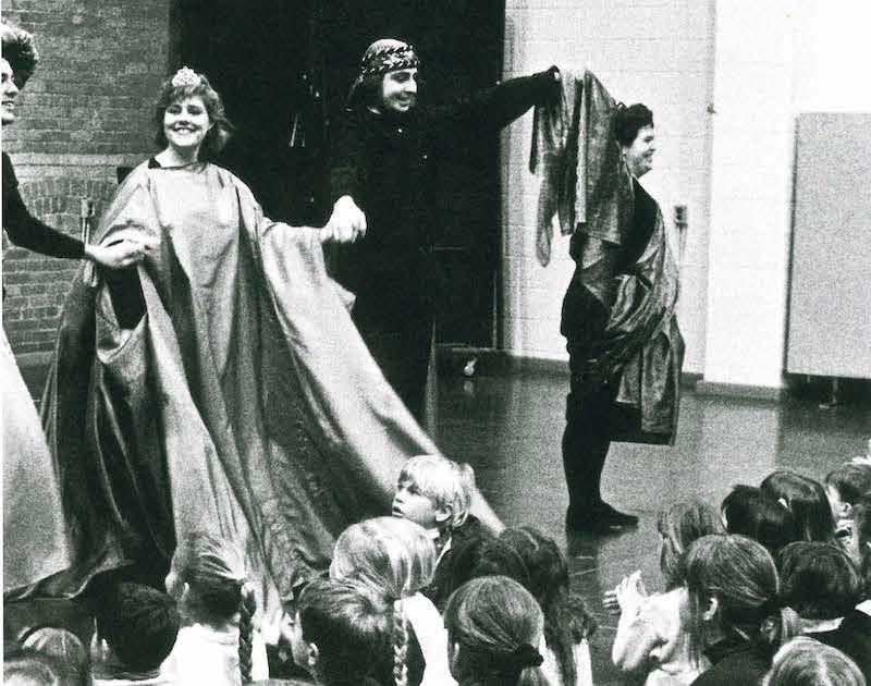 cast of play bowing in front of happy children