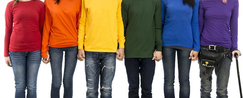 students wearing different colour shirts holding hands