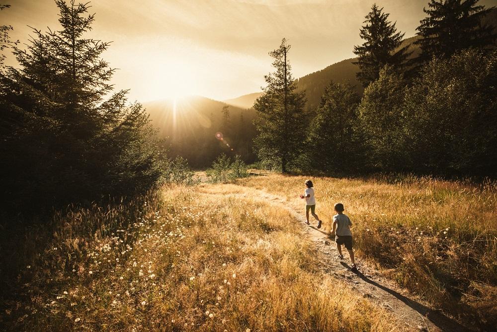 Children running outside in forest