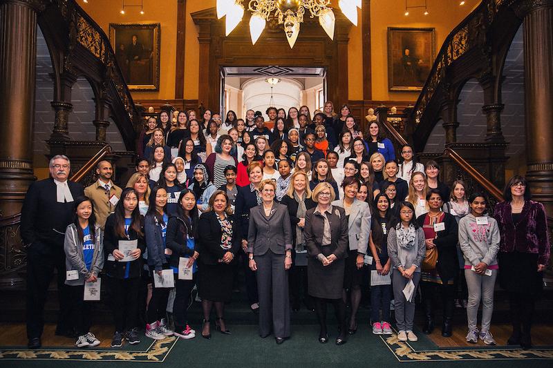 women and girls posing with political leaders