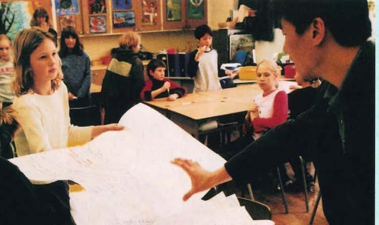 indigenous teacher in front of classroom