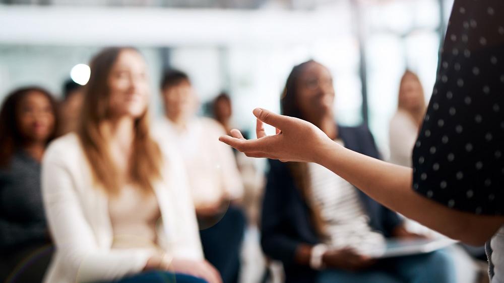 Woman speaking to classroom full of women