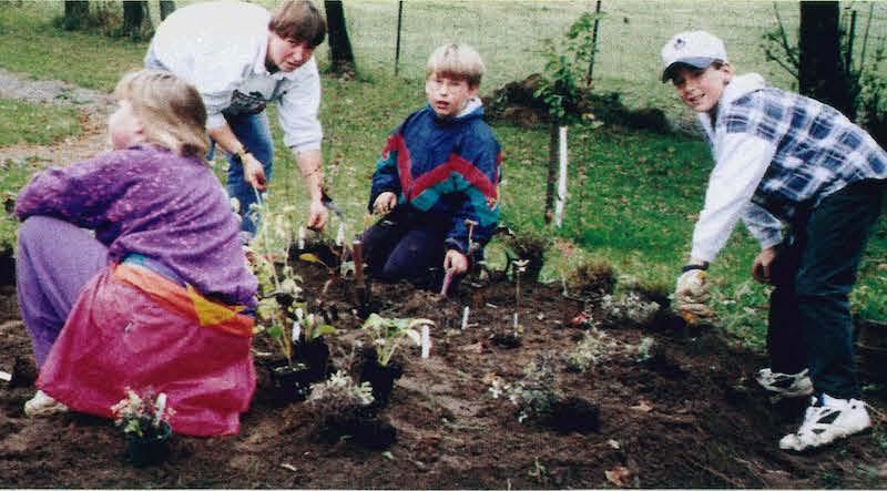 elementary students working in garden