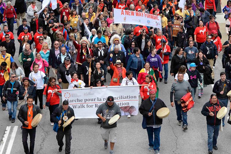 Aboriginal community members marching down street