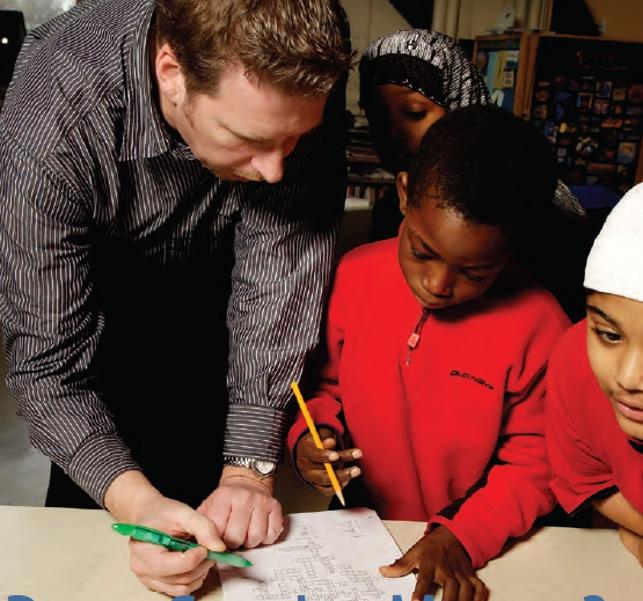 teacher working one on one with student on paper