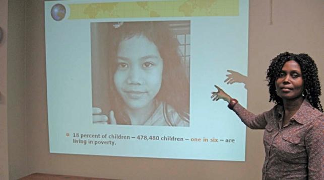 women pointing at projection with a photo of another women displayed