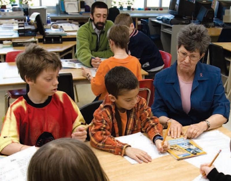 Teachers working with students in classroom