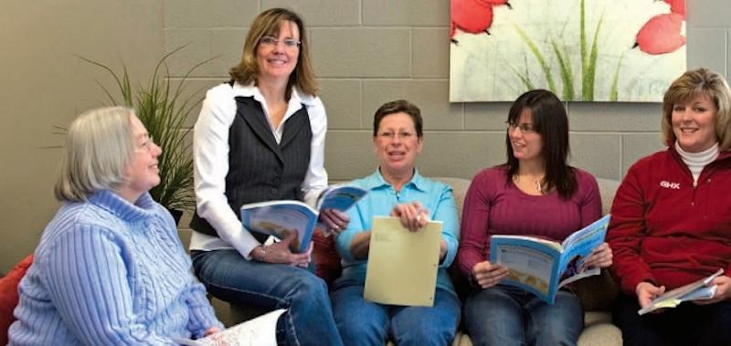 Teachers sitting together with books