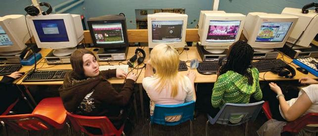 students sitting in computer lab working on computers