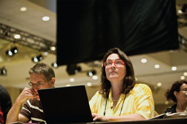 etfo members sitting at table with laptops watching speaker