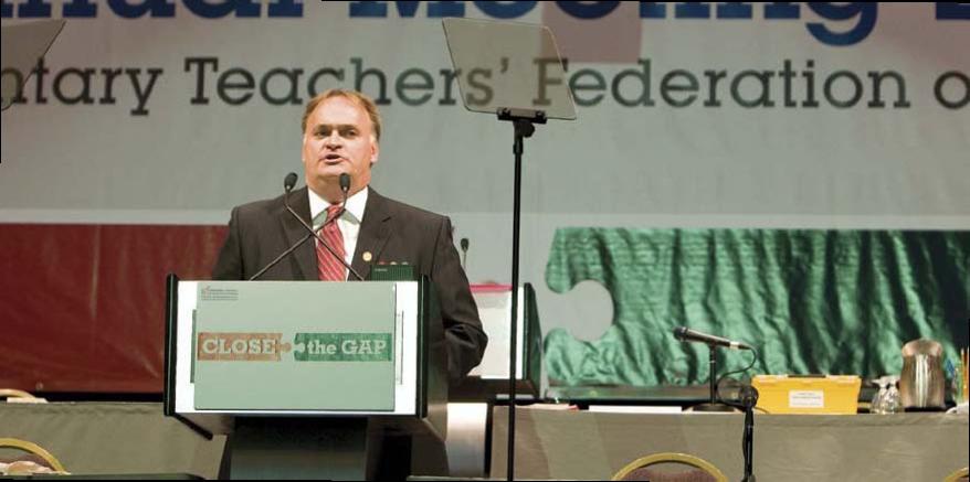 etfo member standing at podium speaking to crowd out of frame