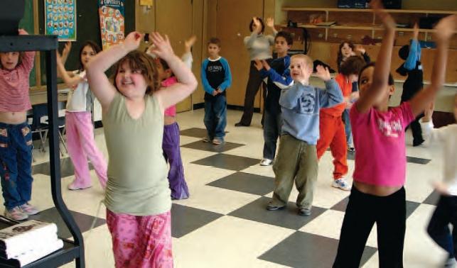 children dancing and playing in classroom