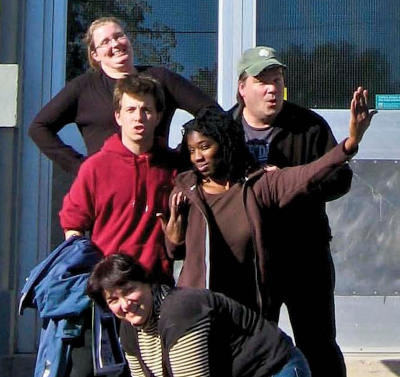 group of play actors posing outside of school