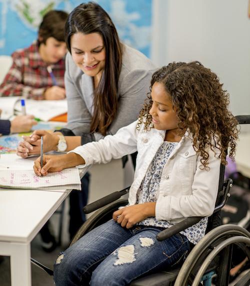 Teacher working with student in wheelchair