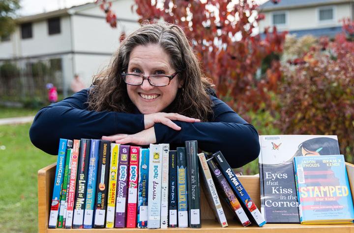 Diana Maliszewski posing outside with books
