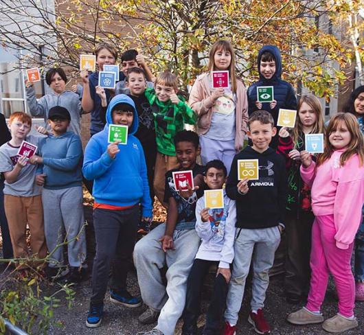 Jen Reid and her students standing outside holding cards