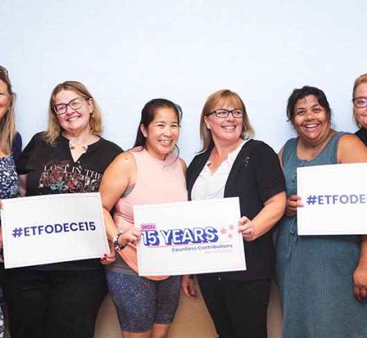 ETFO members holding up signs that celebrate 15 Years of DECE Members' Countless Contributions