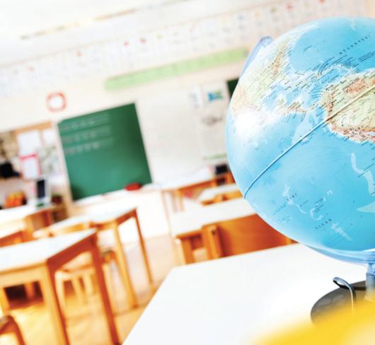 World globe sitting on desk in classroom