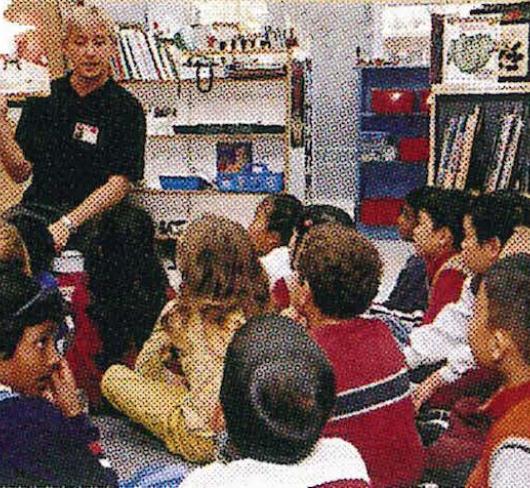 teacher reading to children in classroom