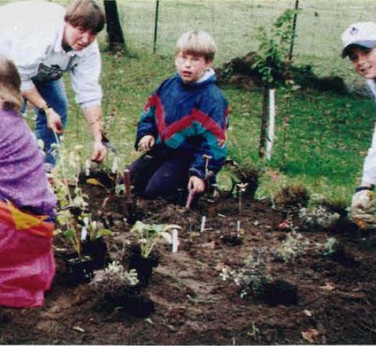 elementary students working in garden