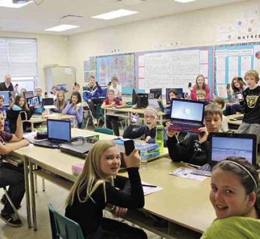 photo of students in classroom working on computers