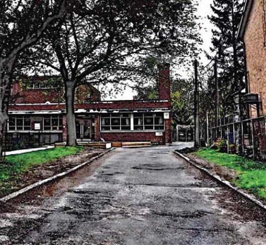 Photo of school with road in foreground and heavy HDR post-editing