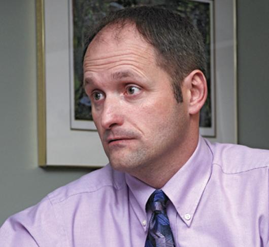 man staring intently at something out of frame
