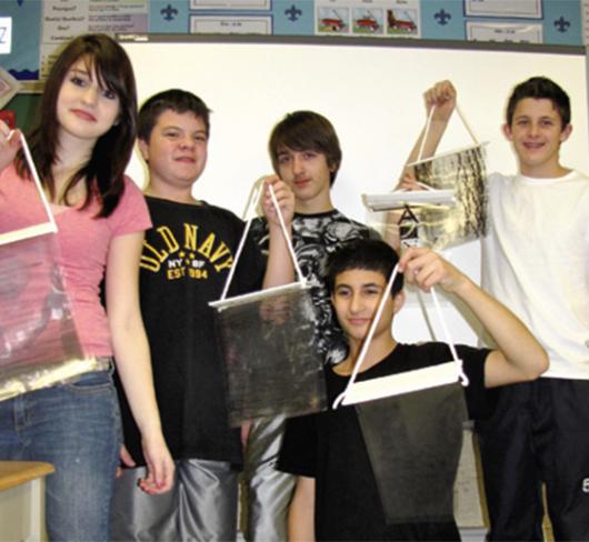 students posing with their art projects