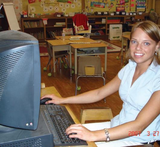 Teacher using computer in classroom