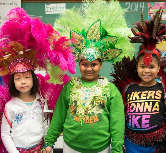 Young elementary students wearing Caribana style headwear